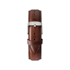 Classic brown leather watch strap from the Steven Harrington x Daniel Wellington set, featuring fine stitching and a polished silver buckle engraved with the DW logo.