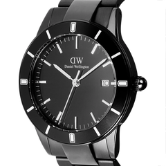 Close-up of the Daniel Wellington Iconic Paradigma Link Black watch, featuring a minimalist black dial, bold index markings, and a polished stainless steel bracelet with a satin matte bezel.