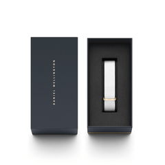 Dover Strap Rose Gold featuring a crisp white polyester nato strap with a rose gold buckle, elegantly presented in a dark Daniel Wellington gift box.