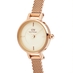 Close-up of the Petite Mini Champagne Melrose watch showing its champagne dial, minimalist markers, and rose gold mesh strap.