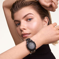 The Daniel Wellington Retro Digital Dark Grey watch with a black digital dial and dark grey link strap is styled on a wrist, showcasing its modern vintage design.