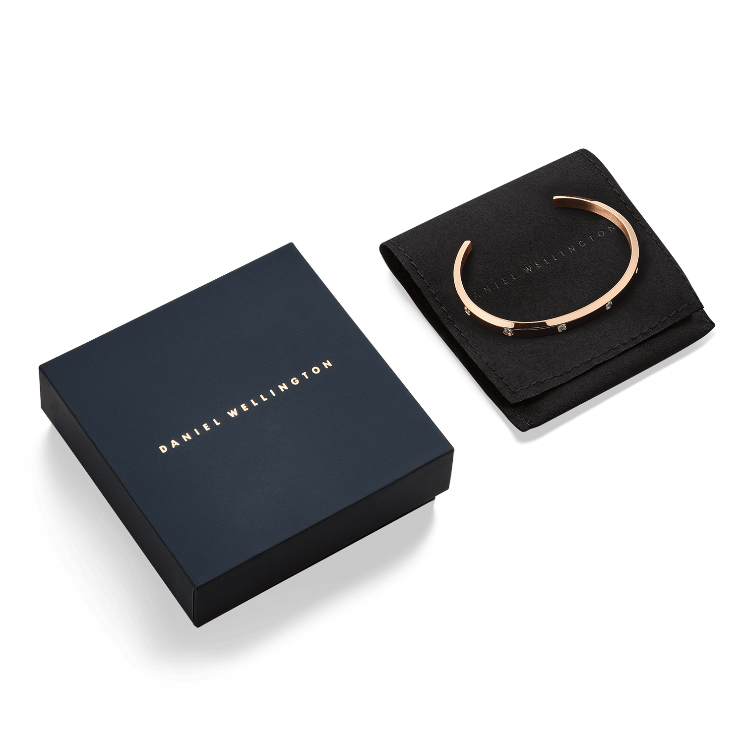 Classic Lumine Bracelet Rose Gold 55mm displayed on a black Daniel Wellington pouch beside its signature navy gift box, highlighting the bracelet’s polished rose gold finish and cubic zirconia crystal detailing.