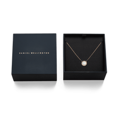 Audrey Necklace Mother of Pearl Rose Gold displayed in an open signature Daniel Wellington gift box, featuring a domed mother of pearl pendant with a halo of white cubic zirconia crystals on a delicate rose gold chain.
