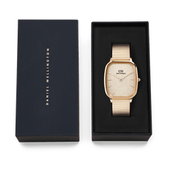 Daniel Wellington Marlon Wire Linen Rose Gold watch presented in a sleek black gift box, featuring a cushion-shaped rose gold case, linen-textured dial, and matching wire mesh strap.