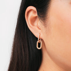 Rose gold Crystal Link Earring with a chunky oval design and sparkling cubic zirconia crystals, shown worn on the ear for a modern, elegant look.