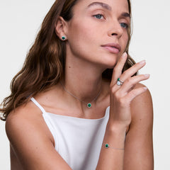 Woman wearing Audrey Ring Malachite Silver with matching malachite earrings, necklace, and bracelet, styled elegantly.