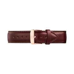 Brown genuine leather watch strap with a tapered design, featuring detailed stitching and a polished rose gold pin buckle engraved with the Daniel Wellington logo. The strap has a smooth finish and quick-release connectors for easy attachment to compatible timepieces.