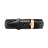 Genuine black leather watch strap with a smooth finish, detailed stitching, and a rose gold buckle engraved with the Daniel Wellington logo.