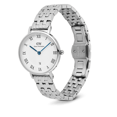 Daniel Wellington Petite Roman Numerals Date 5-link Silver watch featuring a polished stainless steel 5-link strap, white dial with Roman numerals, blue hands, guilloché pattern, and a date window at 6 o’clock, shown with the butterfly clasp open.