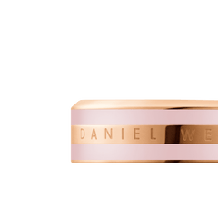 Close-up of the Emalie Ring Cherry Blossom Rose Gold Cherry, showing the rose gold band with cherry blossom pink enamel and the engraved Daniel Wellington logo. The ring highlights a modern, elegant style with subtle pastel detailing.