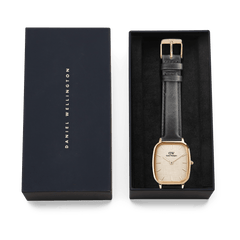 Daniel Wellington Marlon Sheffield Linen Gold watch presented in a signature gift box, featuring a gold cushion-shaped case, linen-textured dial, and black leather strap.