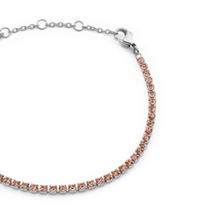 Close-up of the Classic Tennis Bracelet Apricot Silver, highlighting its polished silver chain and individually set apricot-coloured Preciosa crystals with an adjustable lobster clasp.