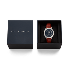 Iconic St Mawes Automatic Silver men’s watch with an arctic blue dial and brown leather strap, presented in an elegant Daniel Wellington gift box.