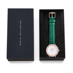 Crystalline Bezel Green Croc Rose Gold watch with a mother of pearl dial, sparkling rose gold case, and emerald green crocodile-textured leather strap, elegantly presented in a black Daniel Wellington gift box.