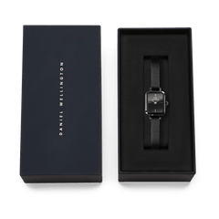 Quadro Mini Reflection Black women’s watch with a rectangular mirror dial and black mesh strap, elegantly presented in a Daniel Wellington gift box.