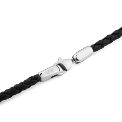Detail of the Daniel Braided Leather Bracelet Sheffield 2.8 Silver, showing the slim black braided leather band and polished silver-tone lobster clasp engraved with the Daniel Wellington logo.