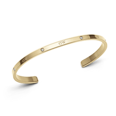 Classic Lumine Bracelet G featuring a slim, polished gold cuff with six sparkling crystals and subtle DW engraving, crafted from stainless steel for a refined, minimalist look.