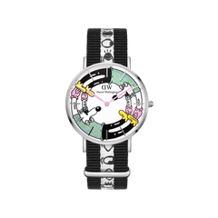 Steven Harrington x DW: NATO Multicolor Printed Dial watch featuring a vibrant, artist-designed face with playful graphics and a black and white NATO strap adorned with signature motifs. The lightweight stainless steel case and adjustable strap offer a modern, creative twist on a classic silhouette.