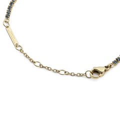 Close-up of the Classic Tennis Bracelet Nightfall Gold, highlighting the adjustable gold chain, secure lobster clasp, and individually set dark Preciosa crystals.