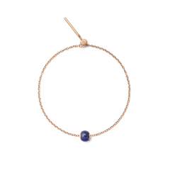 Rose gold bracelet featuring a single orb-shaped charm crafted from deep blue semi-precious stone, offering a minimalist and elegant accessory for everyday wear.