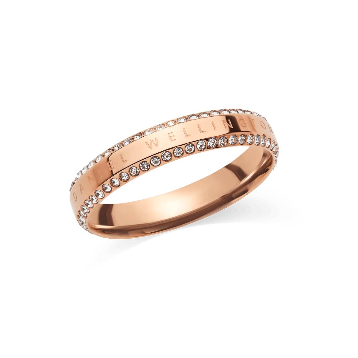 Rose gold ring with a polished finish, featuring two rows of white cubic zirconia crystals along the edges and the Daniel Wellington signature engraved on the band. The design combines classic elegance with a modern touch, making it a versatile accessory for women.