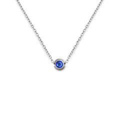 Sterling silver necklace featuring a round blue crystal charm set in a minimalist polished silver setting.