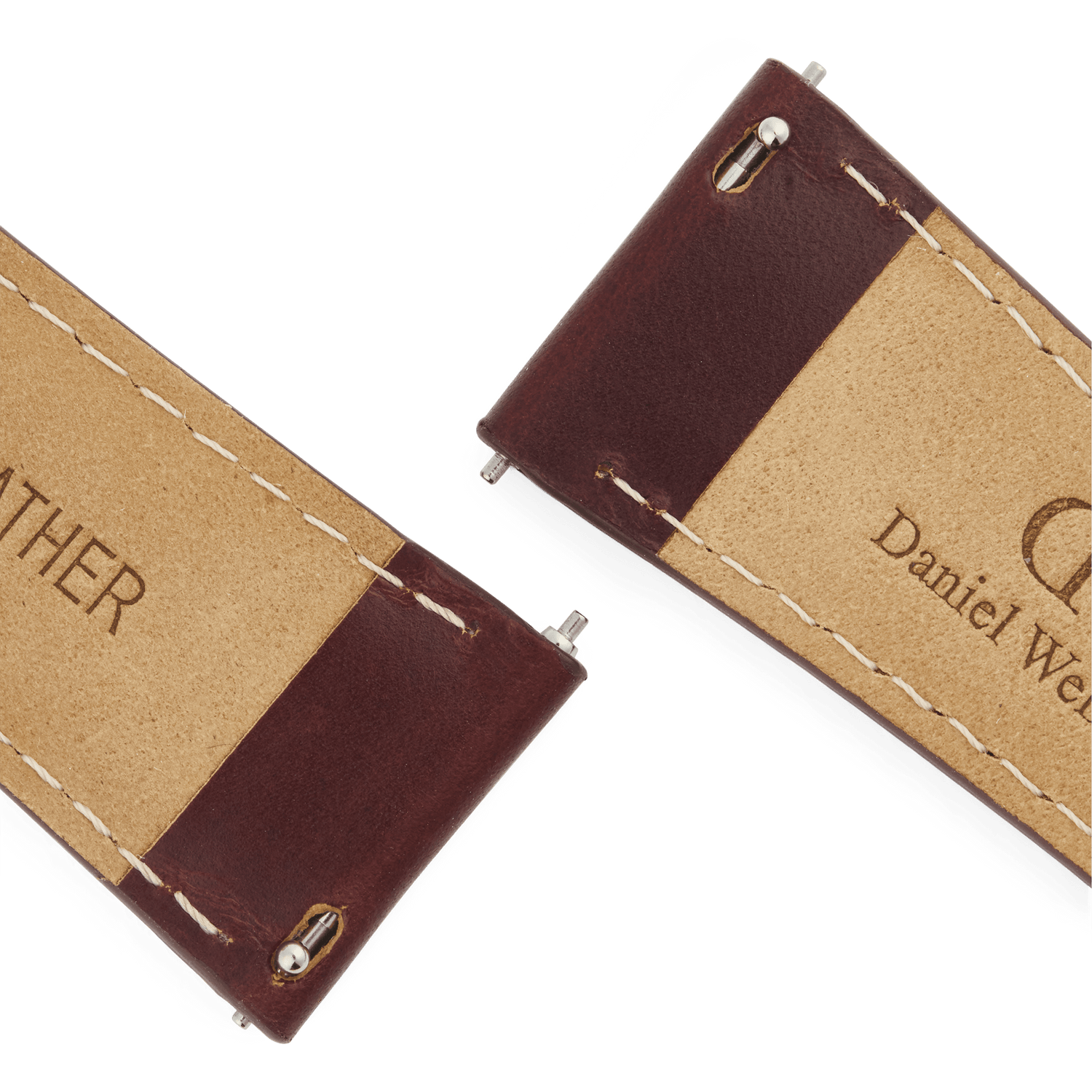 Close-up of the underside of the Tapered St Mawes Strap Gold, showing genuine brown leather with cream contrast stitching and quick-release spring bars for easy attachment. The Daniel Wellington branding is clearly visible, highlighting the quality craftsmanship of the watch strap.