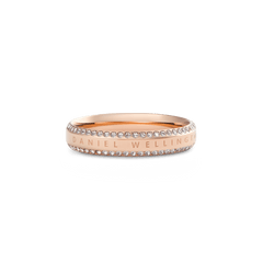 Rose gold Daniel Wellington ring with a polished band, featuring two rows of white cubic zirconia crystals along the edges and an engraved signature for a refined, modern look.