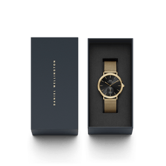 Classic Multi-Eye Evergold Onyx watch with a gold mesh strap and black dial, elegantly presented in a dark Daniel Wellington gift box.