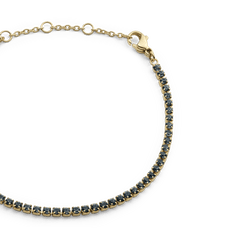 Classic Tennis Bracelet Nightfall Gold featuring a slim gold chain with individually set dark Preciosa crystals and an adjustable lobster clasp fastening.