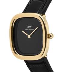 Close-up of the Margot Reading Onyx Ceramic Gold watch, showcasing its polished gold rounded square case, minimalist black ceramic dial, and genuine black Croco leather strap.