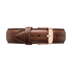 Dark brown genuine leather watch strap with detailed stitching and a polished rose gold buckle engraved with the Daniel Wellington logo, designed for a refined and versatile look.