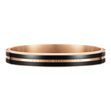Designer Daniel Wellington Emalie Infinite bangle in rose gold with black enamel accents, featuring a smooth silhouette and engraved detailing.