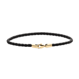 Slim black braided leather bracelet with a polished gold-tone lobster clasp, featuring a minimalist design and subtle Daniel Wellington branding.