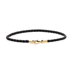 Slim black braided leather bracelet with a polished gold-tone lobster clasp, featuring a minimalist design and subtle Daniel Wellington branding.