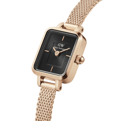 Rectangular Quadro Mini Melrose Onyx women’s watch with a black sunray dial, minimalist index markers, and a rose gold mesh strap, showcasing a refined and elegant design.