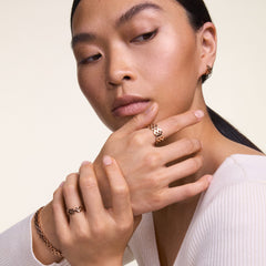 Woman wearing the 3-Link Bracelet Rose Gold on her wrist, styled with matching rose gold jewellery for an elegant, coordinated look.