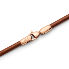 Close-up of the St Mawes Bracelet Rose Gold, highlighting the polished rose gold lobster clasp and smooth brown leather strap.