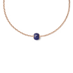 Rose gold chain necklace featuring a single orb-shaped charm made from deep blue semi-precious stone, highlighting minimalist design and elegant colour contrast.
