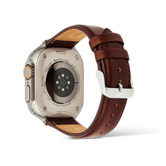 Rear view of an Apple Watch Ultra paired with a St Mawes brown leather strap, showcasing the polished silver pin buckle and detailed stitching for a refined, classic finish.