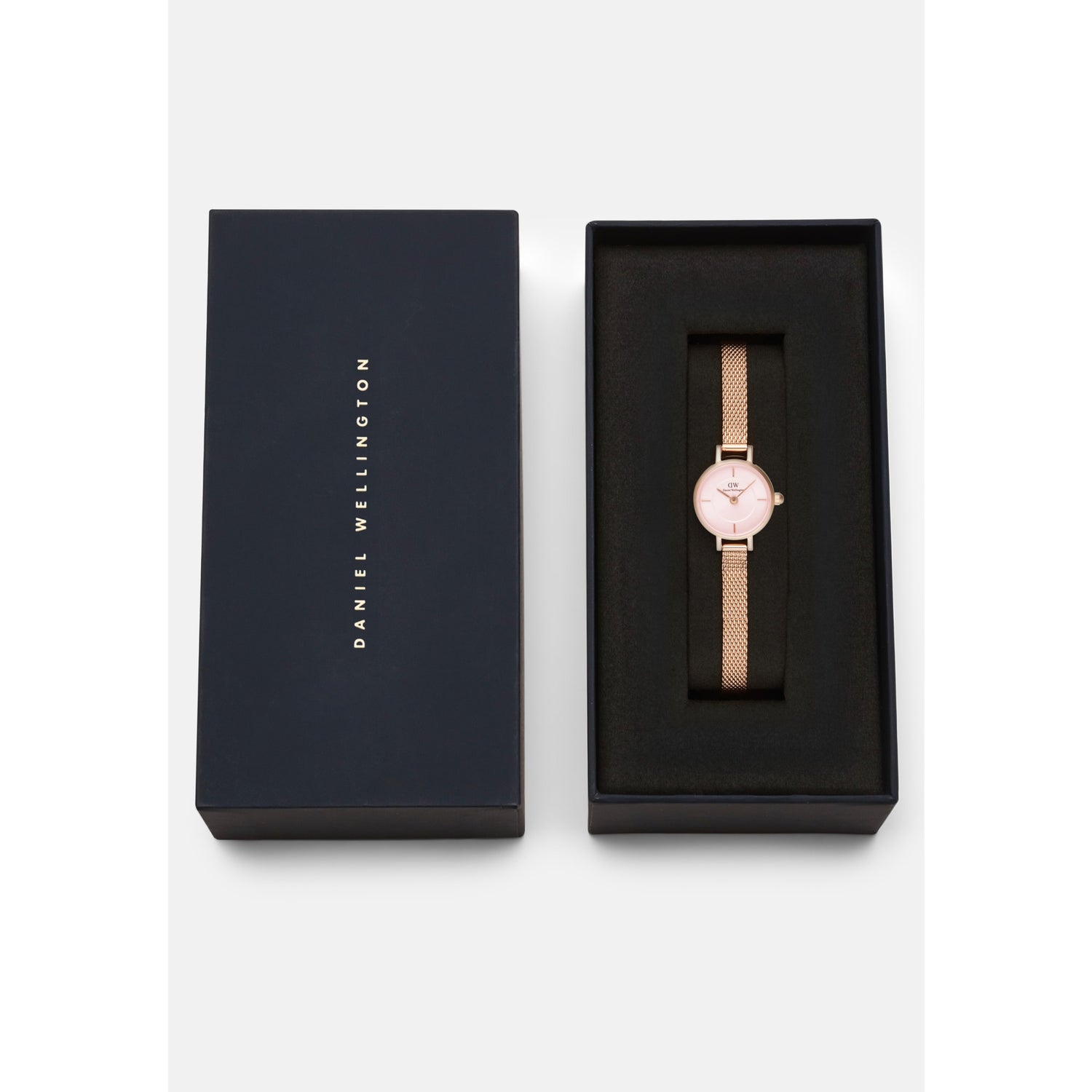 Petite Mini Blush Melrose watch with a blush pink dial and rose gold mesh strap, elegantly presented in a signature Daniel Wellington gift box.