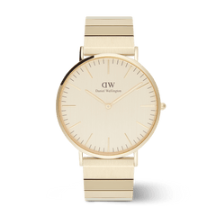 Classic gold Daniel Wellington watch with a brushed gold dial, minimalist face, and distinctive piano link bracelet.