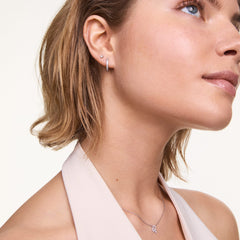 A woman wears the Crystal Hoop Earring Silver, a petite polished silver hoop set with sparkling cubic zirconia crystals, styled for an elegant everyday look.