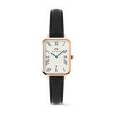Rectangular rose gold women’s watch with a white guilloché dial, black Roman numerals, blue hands, date display at six o’clock, and a black leather strap.