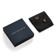 5-Link Earrings Rose Gold presented on a black pouch beside a navy Daniel Wellington gift box, highlighting their elegant geometric design.