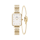 Rectangular gold-tone Daniel Wellington watch with a white dial and minimalist gold markers, paired with a delicate twisted gold chain bracelet featuring an engraved ring, both displayed side by side on a plain background.