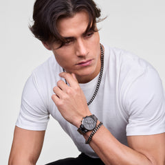 Man wearing the Ellipse Cuban Chain Necklace in graphite, styled with a matching graphite watch and bracelet, paired with a white t-shirt for a modern, sophisticated look.