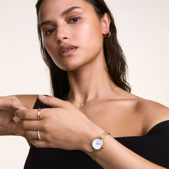 Woman wearing the Petite Mini & Pave Crystal Ring Gold Set, featuring a slim gold mesh strap watch with a white dial and a delicate pavé crystal ring, styled together for an elegant and refined look.