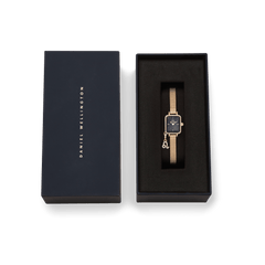 Quadro Mini Crystal Zodiac Evergold Set featuring a gold women’s watch with a rectangular crystal-set case, black mother of pearl dial, and zodiac charm, elegantly presented in a Daniel Wellington gift box.