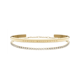 Gold bracelet set featuring a polished Daniel Wellington engraved cuff paired with a delicate tennis bracelet adorned with sparkling crystals, designed for elegant stacking and everyday sophistication.